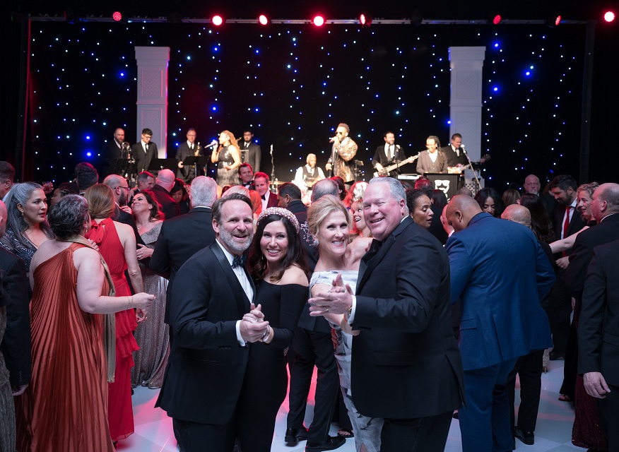 Group of guests on the dance floor with band in background